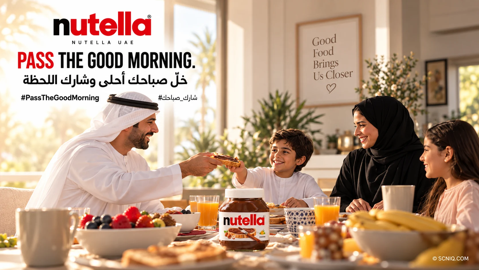 An Emirati family laughing around a sunlit breakfast table as a father and son pass a slice of Nutella toast, with the jar in the centre